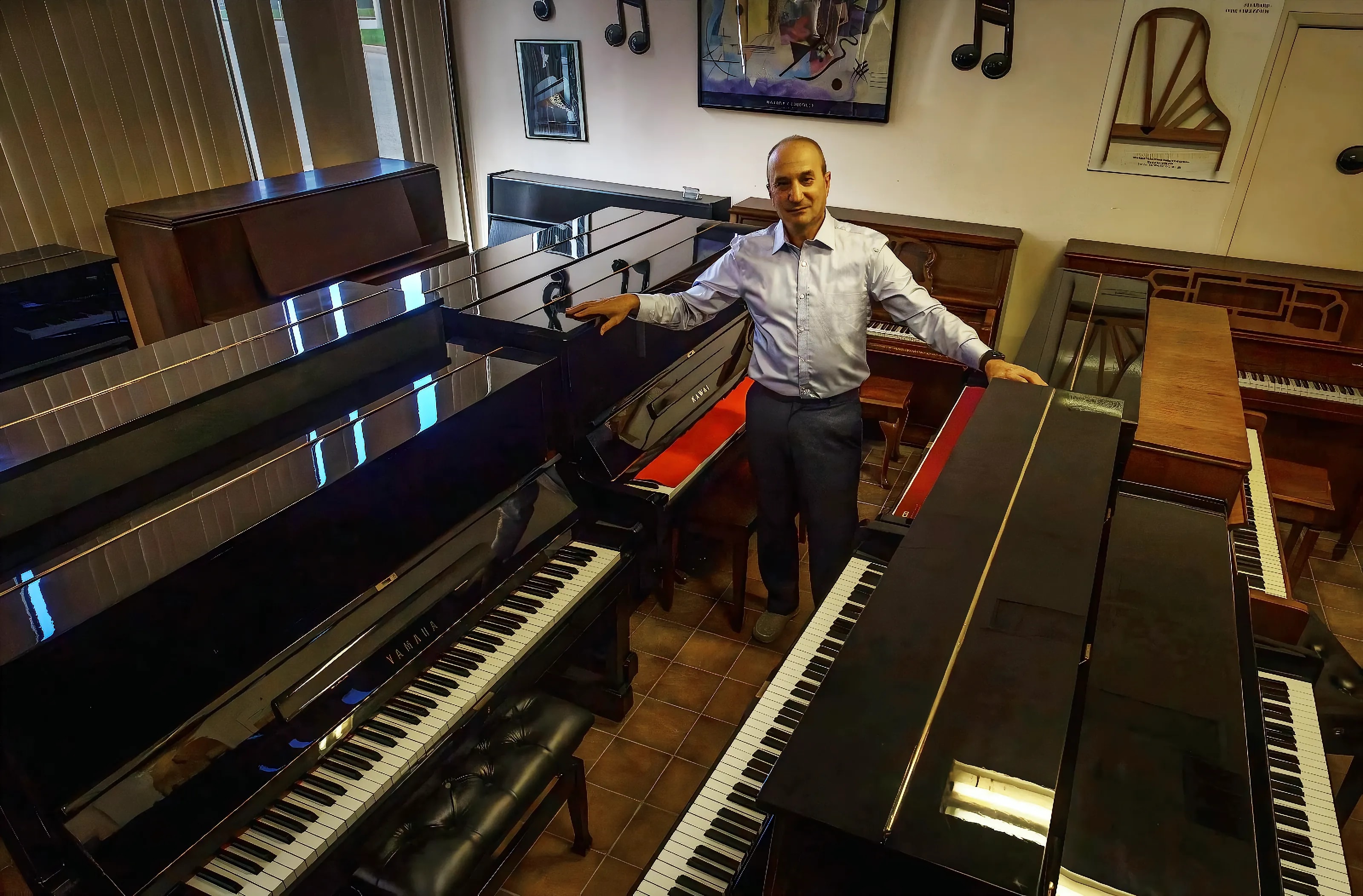 Boris in the Toronto Piano Centre showroom with grand and upright pianos
