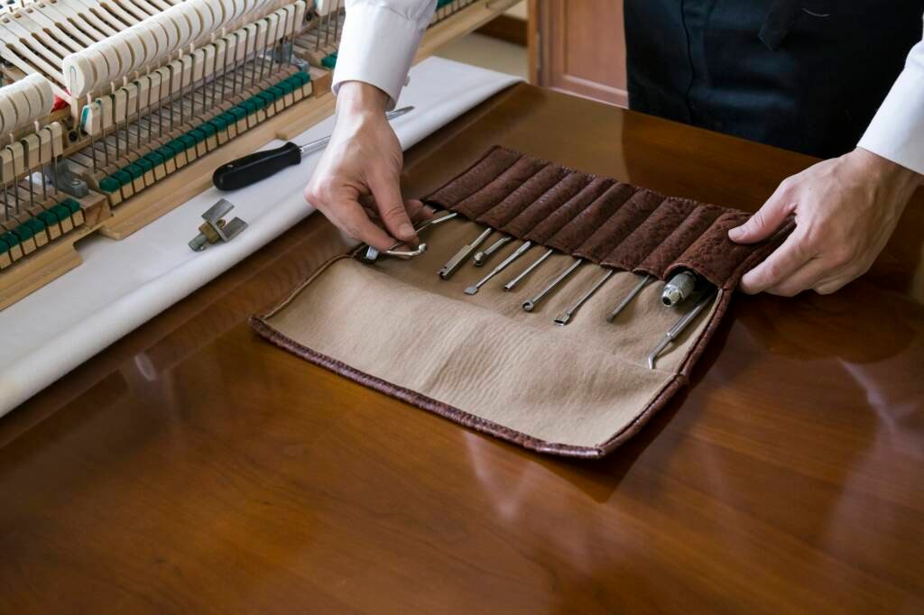 Piano tuner tuning grand piano